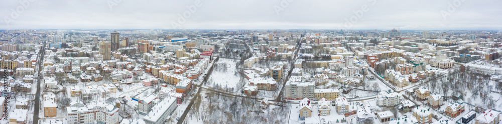 Panorama of the small town and Razderikhinsky ravine in the central part of the city of Kirov on a winter day from above. Russia from the drone.