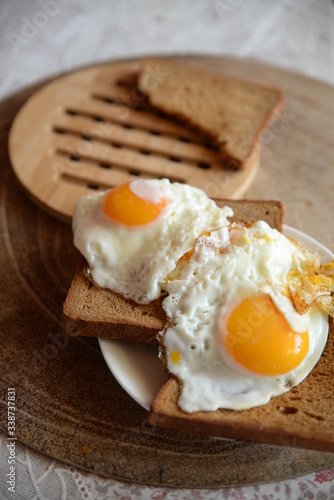 two fried eggs on toast - horizontal photo 