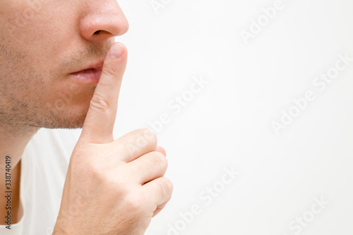 Fényképezés Young man finger showing shush gesture