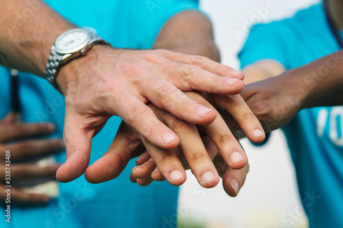 Team of volunteers stacking hands