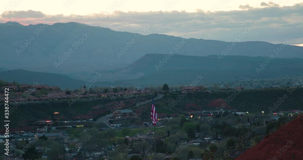 a desert city with an American flag at sunset