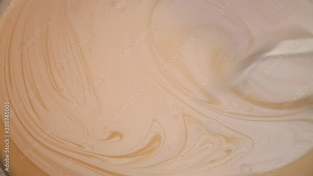Mixing white paint in a bucket Mixing white paint in a bucket