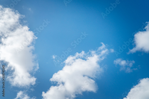 Background nature clear clean blue sky soft clouds beautiful dramatic cloudscape summer sun ray light presents beautiful day life after storm. use as overlay effect or frame with center copy space   © Chan2545