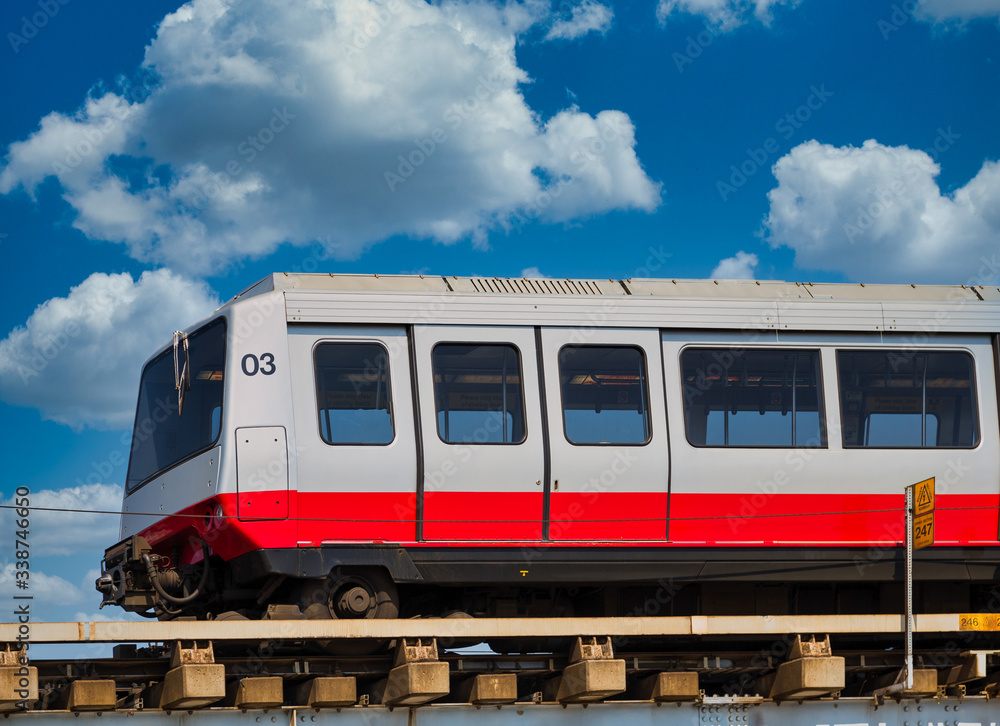 Red and silver mass transit train under blue sky
