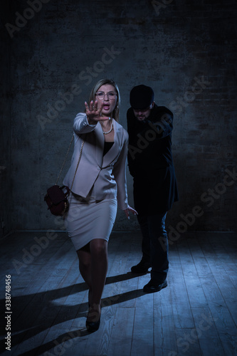 Film noir. Hitman strangled the beautiful businesswoman with black cord