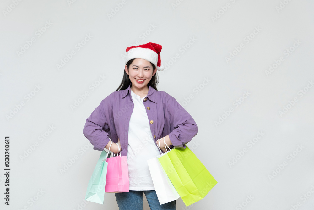 A young asian woman with a shopping bag in her hand