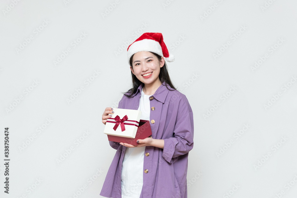A young asian woman with a gift box in her hand A young asian woman with a gift box in her hand