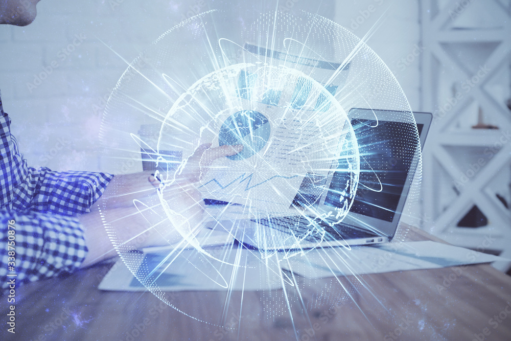 Multi exposure of businessman working on laptop on background. International business hologram in front. Concept of success. Multi exposure of businessman working on laptop on background. International business hologram in front. Concept of success.