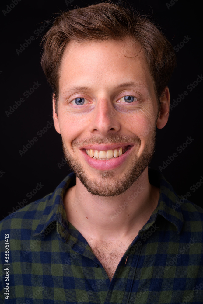 Face of happy bearded hipster man smiling Face of happy bearded hipster man smiling