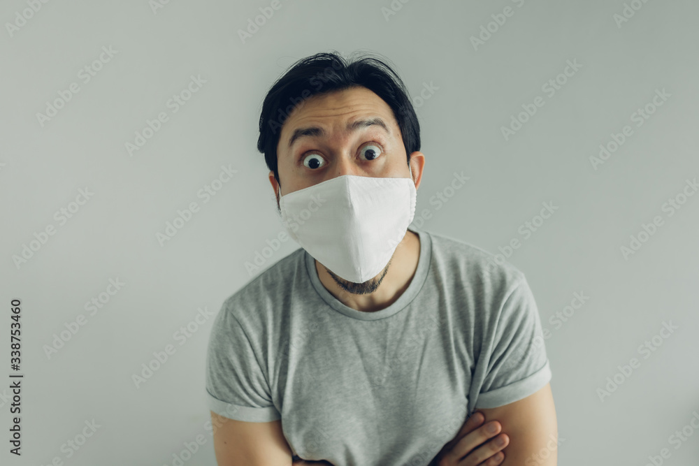 Wow face of Asian man wearing hygienic mask and grey t-shirt. Wow face of Asian man wearing hygienic mask and grey t-shirt.