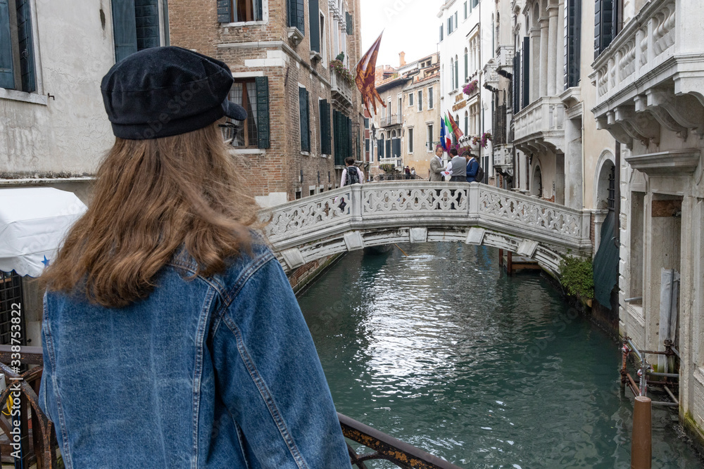 girl standing on a bridge in venice italy