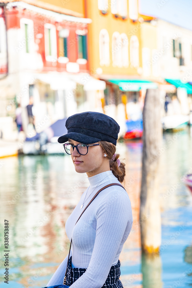 fashion girl in front of a canal in venice murano