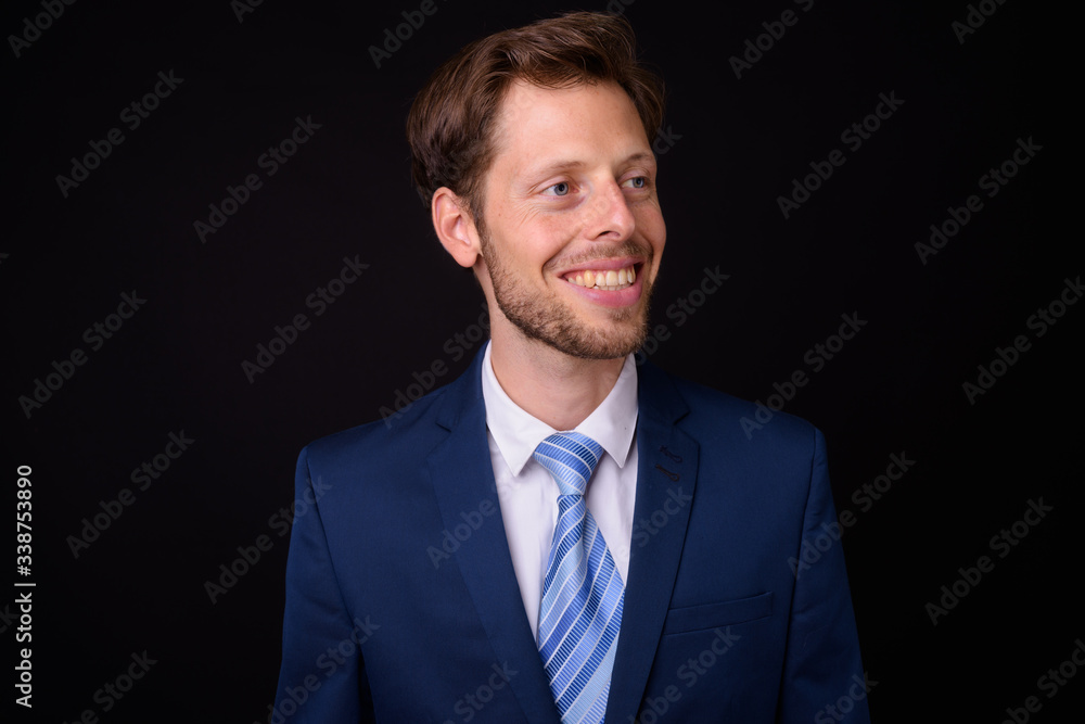 Face of happy bearded businessman in suit thinking Face of happy bearded businessman in suit thinking