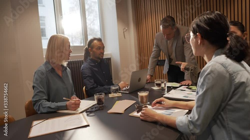 Diverse group of businesspeople talking together and exchanging ideas during a boardroom meeting
