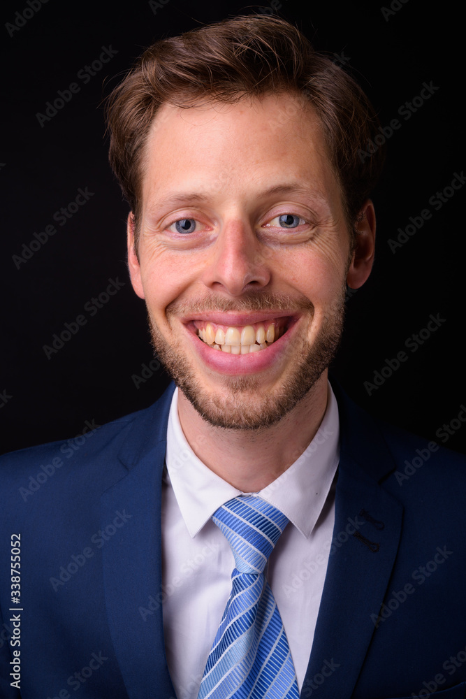 Face of happy bearded businessman in suit smiling Face of happy bearded businessman in suit smiling