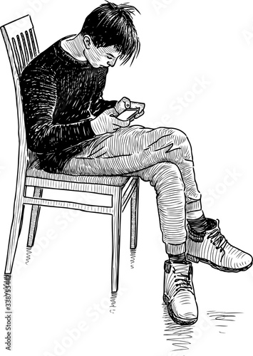 Sketch of teen boy sitting on chair and looking at his mobile phone