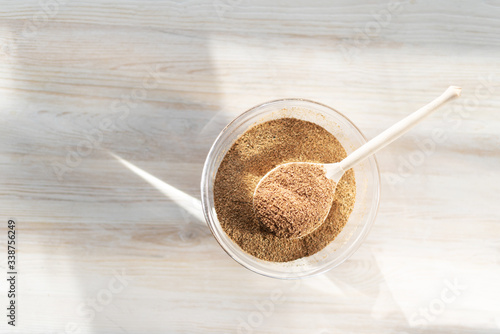 vegetable Fiber lies in a glass bowl on a wooden light background