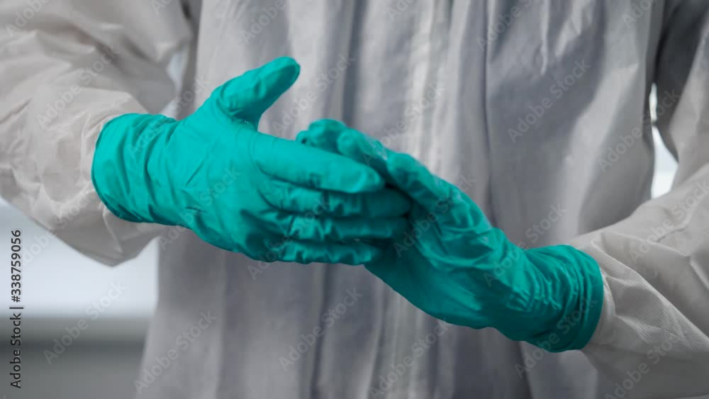 Pandemic Covid-19. A health care worker treats his hands with an antiseptic. A sanitizer is needed to consume viruses and bacteria. Pandemic Covid-19. A health care worker treats his hands with an antiseptic. A sanitizer is needed to consume viruses and bacteria.