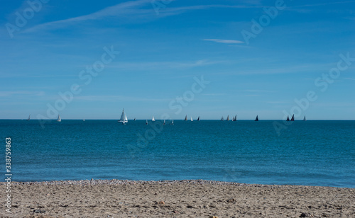 Sailboats sailing on the horizon