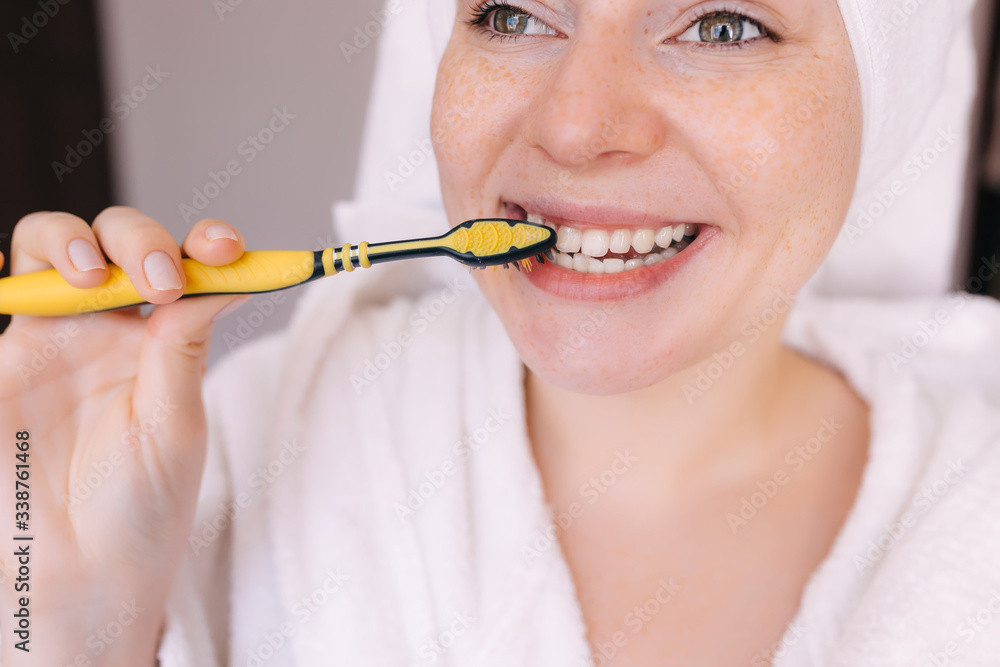 Pretty young healthy woman with toothy smile holding toothbrush Pretty young healthy woman with toothy smile holding toothbrush