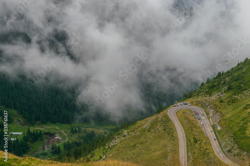 The road that crosses the Fagaras mountains seen from above among the fog, Transfagarasan, Romania