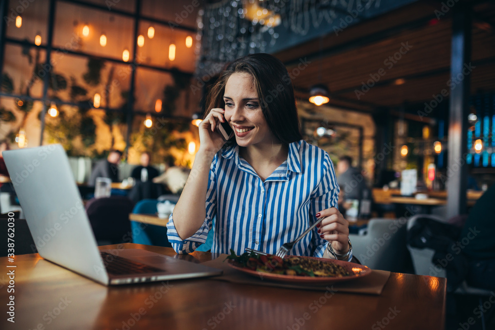 woman using mobile phone in restaurant woman using mobile phone in restaurant