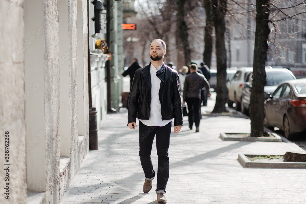 Portrait of fashionable well dressed man with beard posing outdoors Portrait of fashionable well dressed man with beard posing outdoors