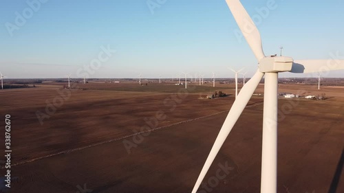 Wind Turbines In The Middle Of The Agricultural Farm In Ubly, Michigan Against The Blue Sky.-closeup shot photo