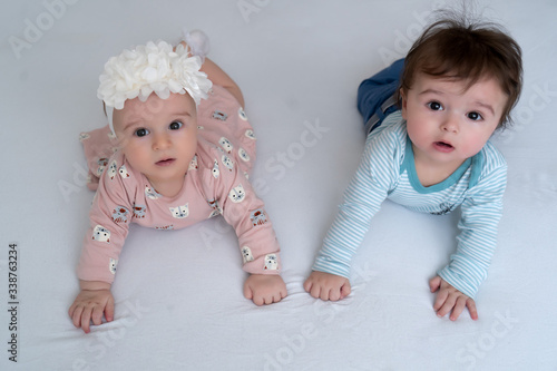 фотографія Two adorable twin babies smiling happily