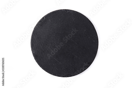 Empty black round slate plate isolated on white background