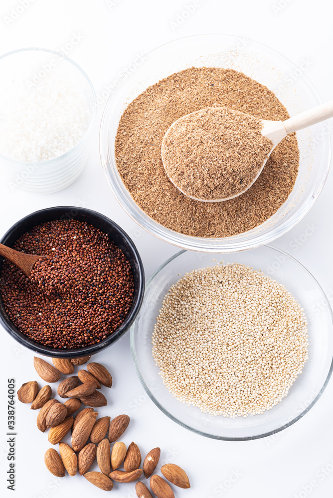 fiber, coconut, almonds and seeds of red and white quinoa on a white background fiber, coconut, almonds and seeds of red and white quinoa on a white background