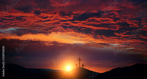 Resurrection of Jesus Christ concept: God Lamb in front of the three cross of Jesus Christ on sunrise background