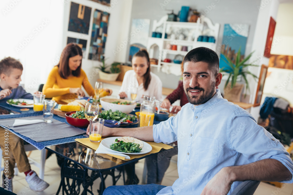 family gathering having dinner or lunch party at home. man posing family gathering having dinner or lunch party at home. man posing