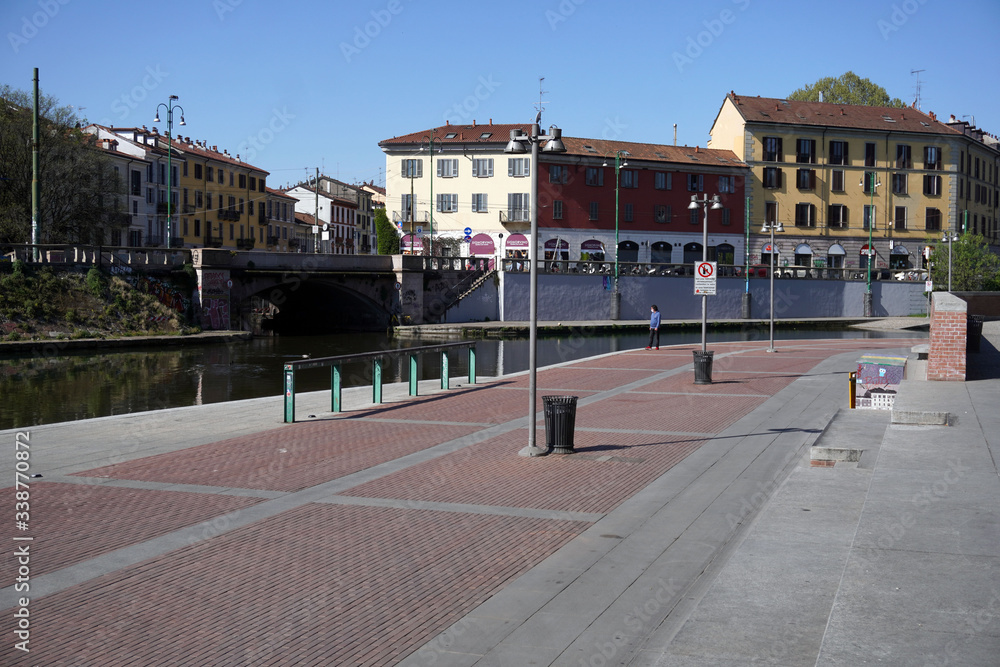 Obraz premium Italy , Milan - APRIL 2020 Darsena old harbor in Navigli Canals ( Naviglio Pavese ) Downtown of the city empty of people during n-cov19 Coronavirus outbreak epidemic quarantine home