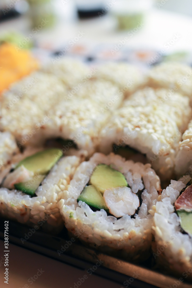 Sushi roll in sesame seeds with tiger prawns Sushi roll in sesame seeds with tiger prawns