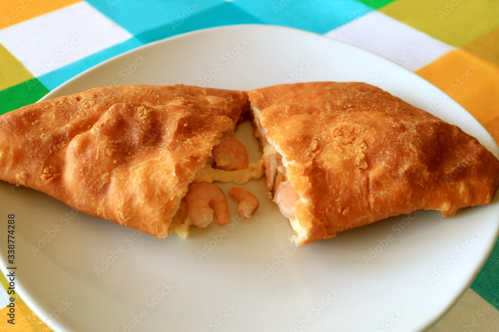 Plate of Empanada de Camarones or Shrimps and Cheese Filled Stuffed Pastry Cut in Half Plate of Empanada de Camarones or Shrimps and Cheese Filled Stuffed Pastry Cut in Half
