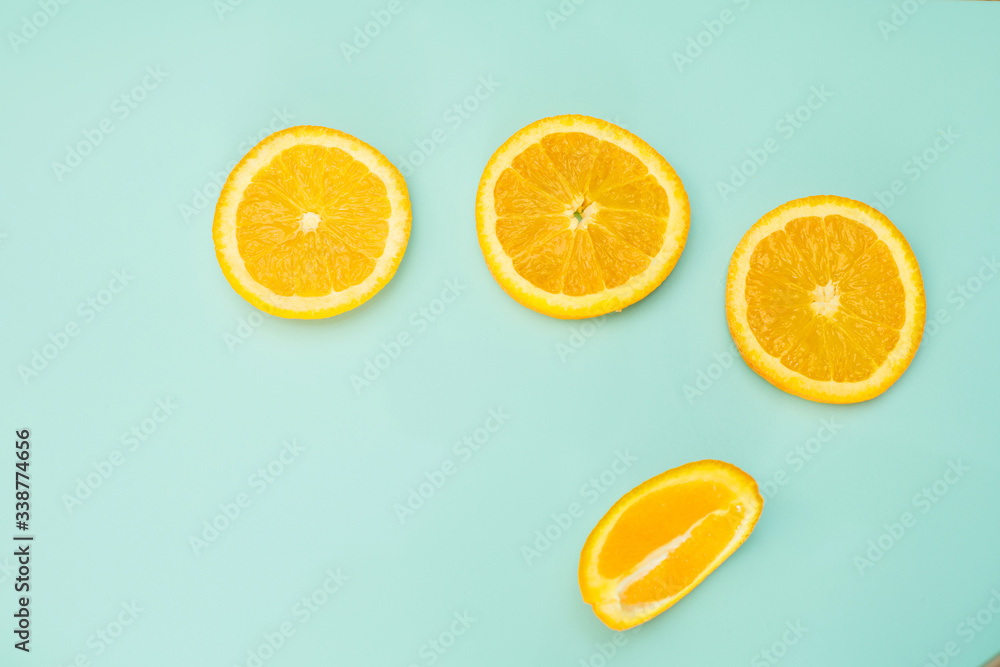 Fototapeta premium sliced orange on a bright green background