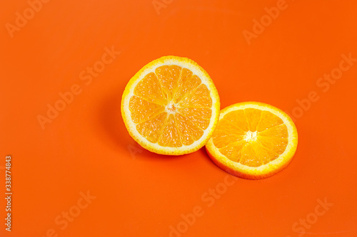 sliced orange on a bright orange background