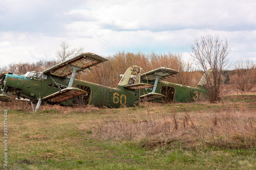 Old destroyed Soviet abandoned military airplanes in the field in Ukraine