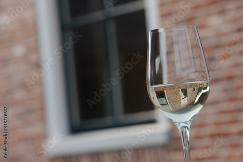 Glass of white wine. Restaurant. Reflections.