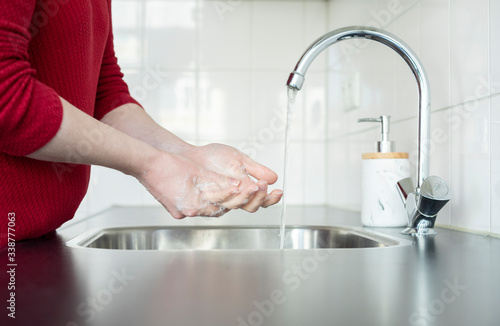 Washing hands in kitchen