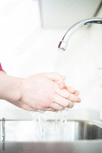 Woman washing hands in kitchen