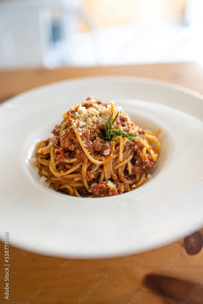 Spaghetti bolognese served on a white plate