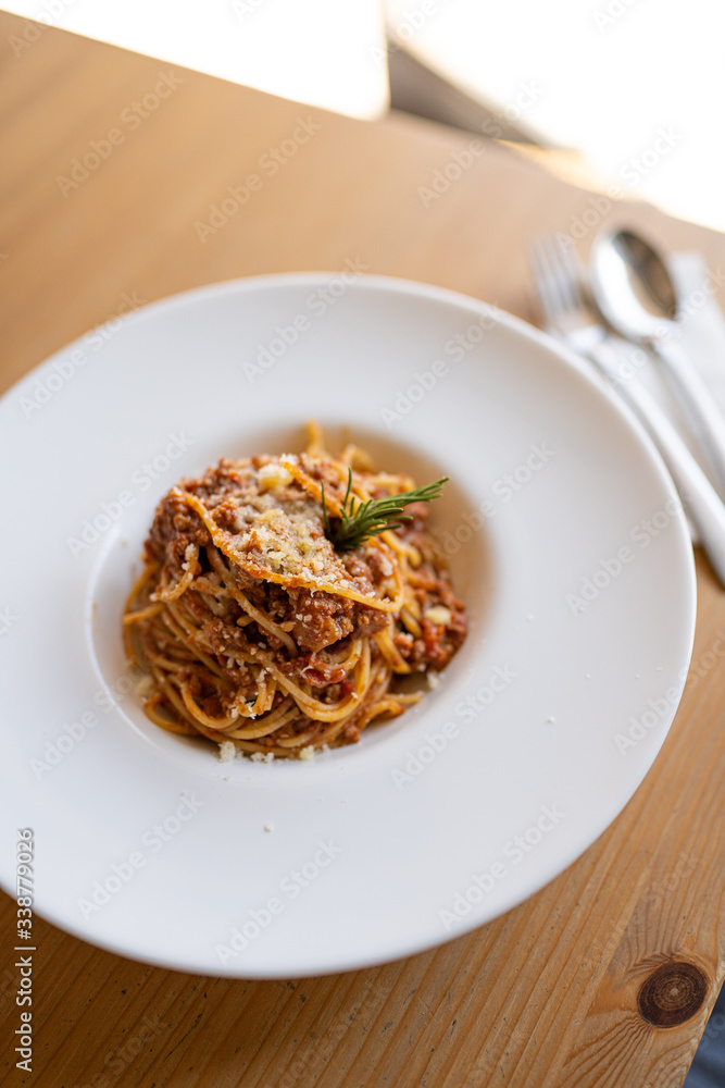 Spaghetti bolognese served on a white plate