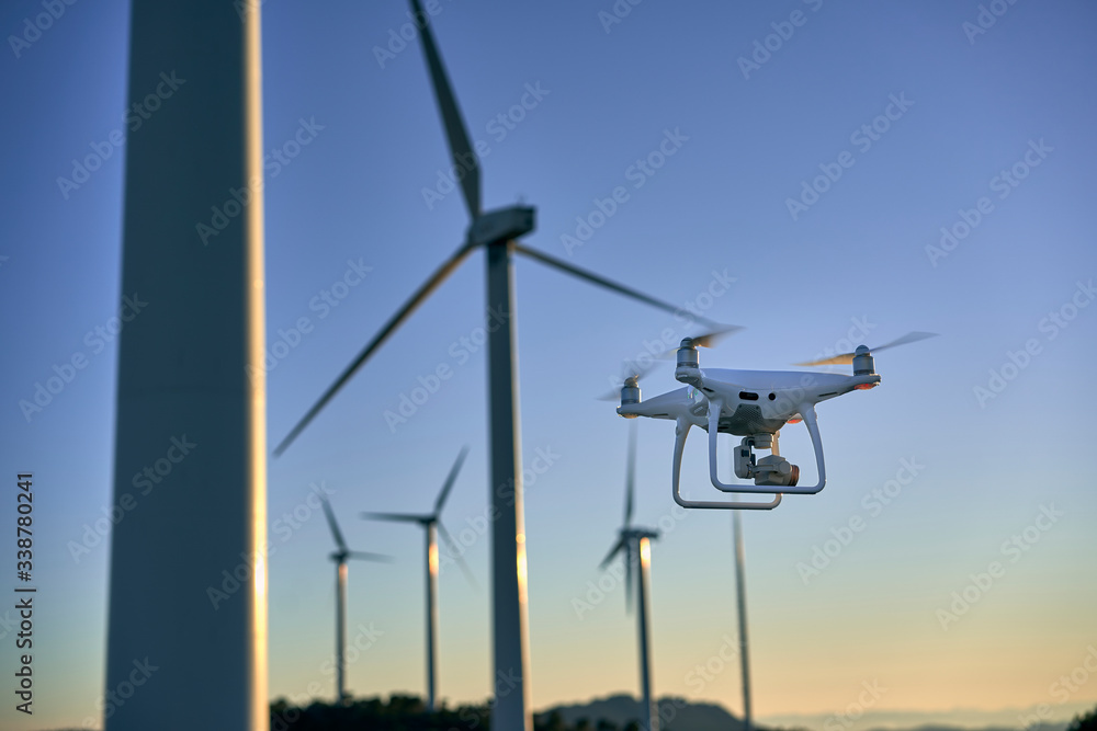 Drone flying over a background of wind turbines Drone flying over a background of wind turbines