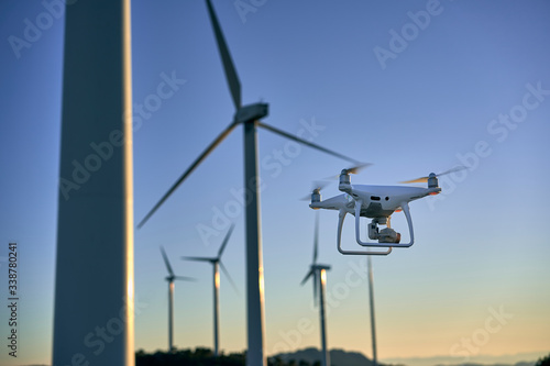 Drone flying over a background of wind turbines