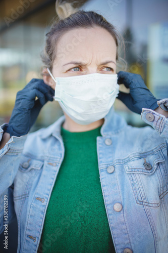 portrait of young beautiful woman wearing mouth face mask during covid 19 or corona crisis