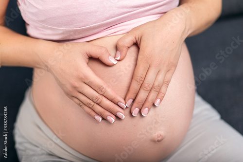 Wallpaper Mural Palms in the form of a heart on the belly of a pregnant woman Torontodigital.ca