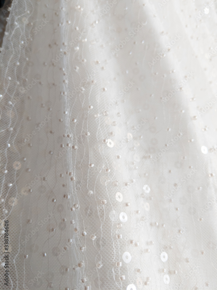 close up on shiny bridal white round sequin fabric texture detail close up on shiny bridal white round sequin fabric texture detail