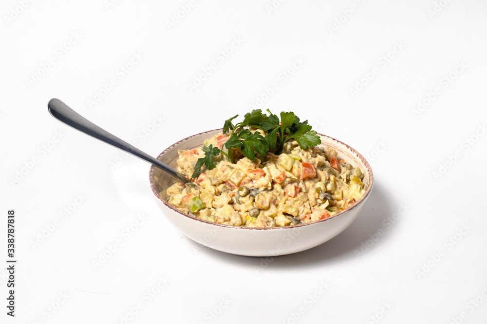 Olivier salad - a classic recipe with mayonnaise, an incredible taste. Olivier salad on a white background, homemade recipe. Olivier salad - a classic recipe with mayonnaise, an incredible taste. Olivier salad on a white background, homemade recipe.